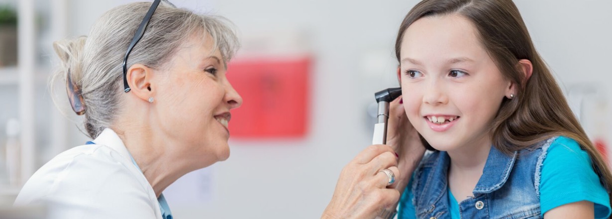 Photo of a doctor examining a patient’s ear