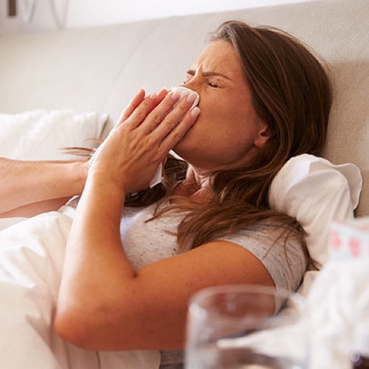 Woman blowing her nose